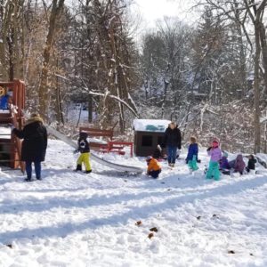 Playing in the snow on the MHCNS&K playground